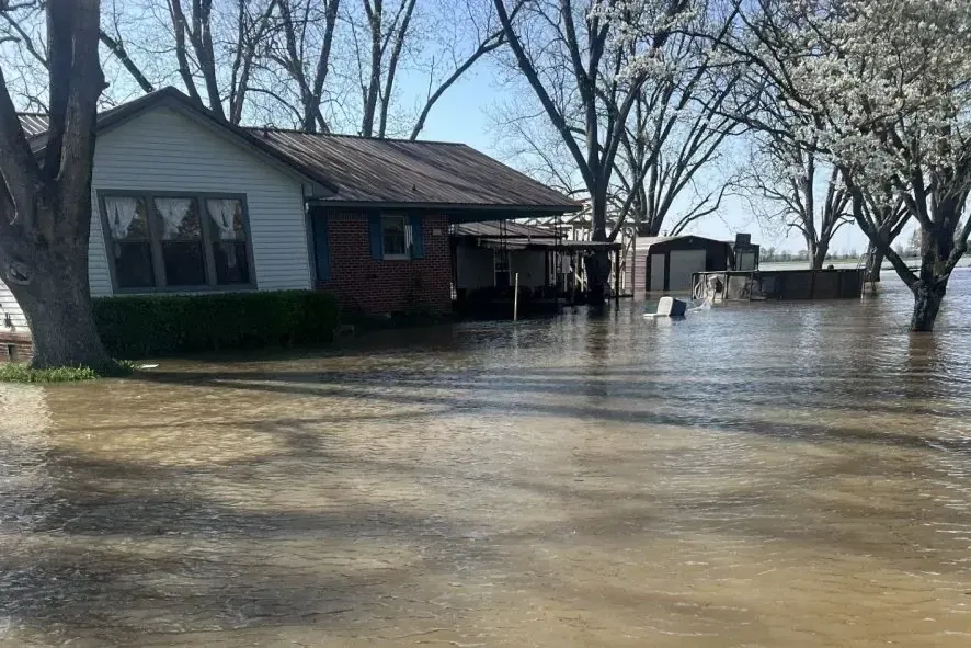 Floodwater surrounding a ranch house after a nearby creek overflowed