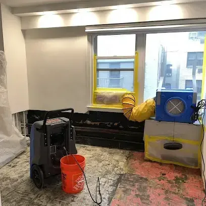 An air mover drying a room after water damage, an example of work for Malibu homes