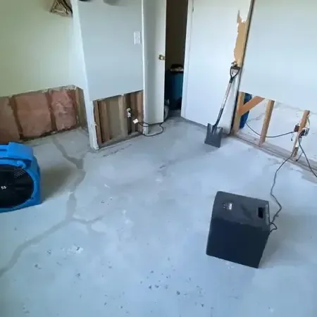Santa Monica drying setup: air movers and a dehumidifier in a room with the lower drywall removed