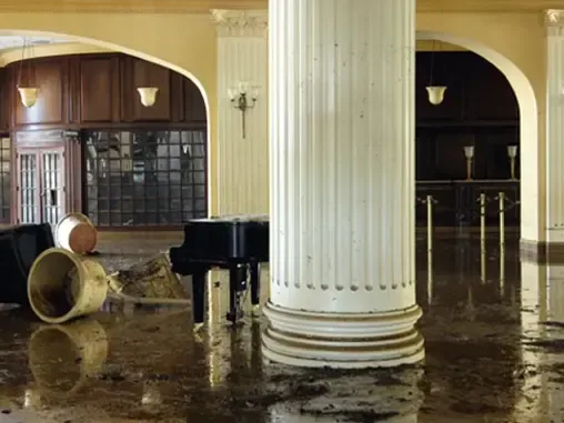 Water spread across the floor of a large commercial hall