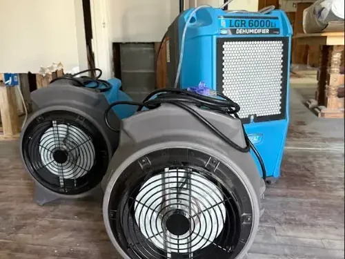 Air movers and an LGR dehumidifier set up for structural drying